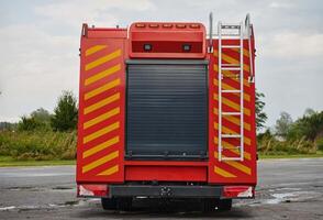 A state-of-the-art firetruck, equipped with advanced rescue technology, stands ready with its skilled firefighting team, prepared to intervene and respond rapidly to emergencies, ensuring the safety photo