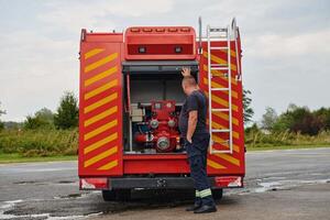 A state-of-the-art firetruck, equipped with advanced rescue technology, stands ready with its skilled firefighting team, prepared to intervene and respond rapidly to emergencies, ensuring the safety photo