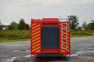 A state-of-the-art firetruck, equipped with advanced rescue technology, stands ready with its skilled firefighting team, prepared to intervene and respond rapidly to emergencies, ensuring the safety photo