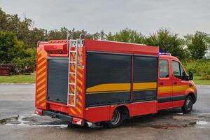 A state-of-the-art firetruck, equipped with advanced rescue technology, stands ready with its skilled firefighting team, prepared to intervene and respond rapidly to emergencies, ensuring the safety photo