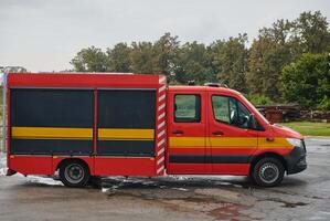 A state-of-the-art firetruck, equipped with advanced rescue technology, stands ready with its skilled firefighting team, prepared to intervene and respond rapidly to emergencies, ensuring the safety photo