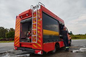 A state-of-the-art firetruck, equipped with advanced rescue technology, stands ready with its skilled firefighting team, prepared to intervene and respond rapidly to emergencies, ensuring the safety photo