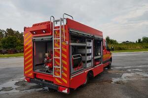 A state-of-the-art firetruck, equipped with advanced rescue technology, stands ready with its skilled firefighting team, prepared to intervene and respond rapidly to emergencies, ensuring the safety photo