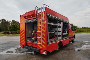 A state-of-the-art firetruck, equipped with advanced rescue technology, stands ready with its skilled firefighting team, prepared to intervene and respond rapidly to emergencies, ensuring the safety photo