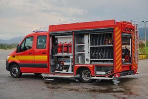 A state-of-the-art firetruck, equipped with advanced rescue technology, stands ready with its skilled firefighting team, prepared to intervene and respond rapidly to emergencies, ensuring the safety photo