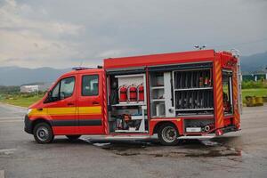 A state-of-the-art firetruck, equipped with advanced rescue technology, stands ready with its skilled firefighting team, prepared to intervene and respond rapidly to emergencies, ensuring the safety photo