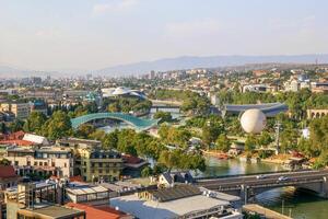 Tbilisi, Georgia - September 22, 2022. View on a city from bank of Kura River on sunny autumn day. photo