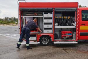 A dedicated firefighter preparing a modern firetruck for deployment to hazardous fire-stricken areas, demonstrating readiness and commitment to emergency response photo