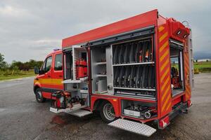 A state-of-the-art firetruck, equipped with advanced rescue technology, stands ready with its skilled firefighting team, prepared to intervene and respond rapidly to emergencies, ensuring the safety photo