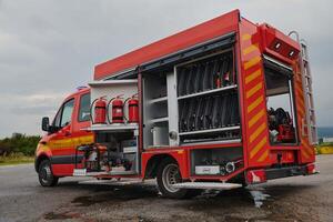 A state-of-the-art firetruck, equipped with advanced rescue technology, stands ready with its skilled firefighting team, prepared to intervene and respond rapidly to emergencies, ensuring the safety photo