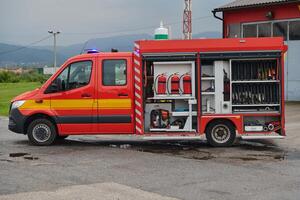 A state-of-the-art firetruck, equipped with advanced rescue technology, stands ready with its skilled firefighting team, prepared to intervene and respond rapidly to emergencies, ensuring the safety photo