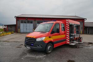 A state-of-the-art firetruck, equipped with advanced rescue technology, stands ready with its skilled firefighting team, prepared to intervene and respond rapidly to emergencies, ensuring the safety photo