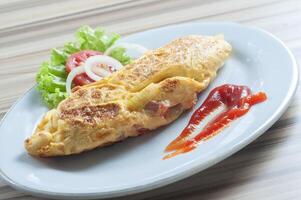 Rolled egg omelets filled with chicken garnished with mayonnaise and sliced tomatoes photo