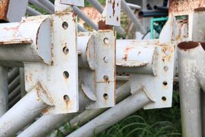 Old rusted and unused scrap metal poles are piled up in abandoned places as industrial scrap. photo