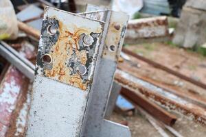 Old rusted and unused scrap metal poles are piled up in abandoned places as industrial scrap. photo