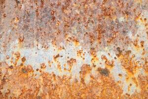 Corroded metal background. Rusted grey painted metal wall. Rusty metal background with streaks of rust. Rust stains. photo