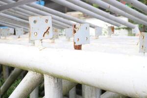 Old rusted and unused scrap metal poles are piled up in abandoned places as industrial scrap. photo