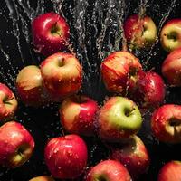 Fresh red apples splash in water, creating a vibrant and healthy image of nature's juicy goodness photo