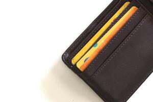Leather wallet with credit card inside it, isolated on white background with copy space area photo