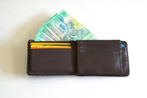 Leather wallet with bank card and Indonesian rupiah banknotes, Twenty thousand rupiah in wallet isolated on white background photo