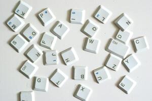 Scattered keyboard buttons on white background, illustration of keyboard typing photo