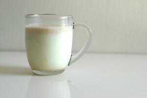A glass of cereal in milk, transparent glass cup of cereal milk for breakfast with copy space area photo