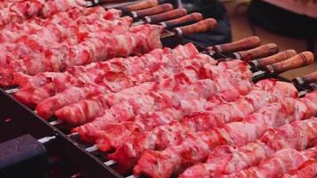 Meat skewers sizzle on hot grill, charred marks, releasing mouthwatering aroma video