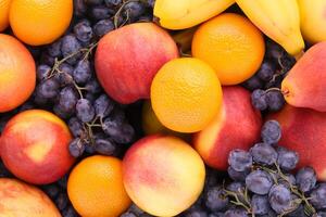 Beautiful Tropical Fruits Background A Luscious Display of Nature's Bounty, Featuring an Abundance of Colorful and Exotic Fruits Against a Vibrant and Refreshing Backdrop photo