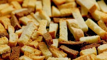 white bread croutons on flat surface, full-frame closeup spinning view video