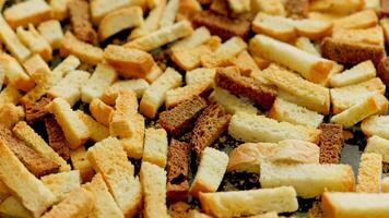 white bread croutons on flat surface, full-frame closeup spinning view video