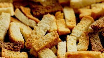 white bread croutons on flat surface, full-frame closeup spinning view video