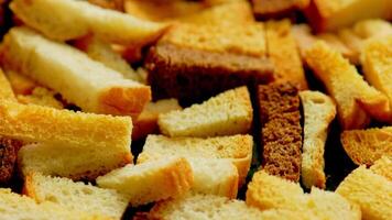 white bread croutons on flat surface, full-frame closeup spinning view video
