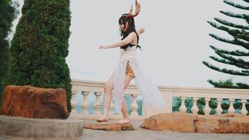 Woman in fantasy costume with horns on stone pathway video