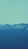 Awesome top view through clouds to high snowy mountains video
