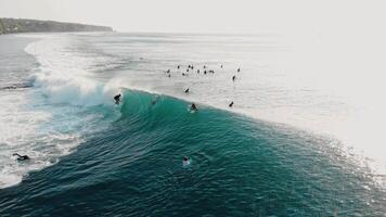 Drone view of surfing at fast barrel wave. Surfer riding on swell waves in Bali video