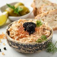 Close up of a bowl of Taramasalata Fish Roe Dip on a rustic table photo