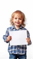 A little boy joyfully holding a white board in his hands photo