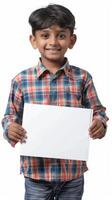 A cheerful Indian boy holding a blank white board in his hands photo