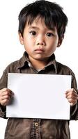 A young Chinese boy holds up a blank white sign with curiosity and innocence photo