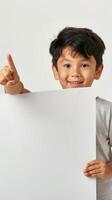 A young Chinese boy enthusiastically holds a blank white board, giving a thumbs up photo