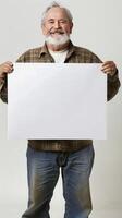 Smiling mature man holding a blank white board in his hands photo