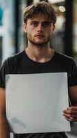 A sad man holding a blank white board photo