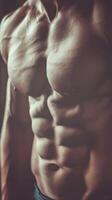 A strong man displaying his bare chest confidently photo