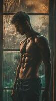 Shirtless man standing confidently in front of a window photo