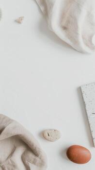 White table adorned with eggs and paper in a serene, minimalist setting photo