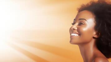 A beautiful mid-aged African woman smiles brightly, illuminated by a golden light photo