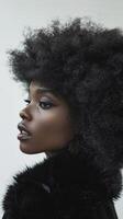 A black and white portrait of a woman with a large afro photo