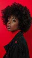 A candid portrait of a woman with an afro, wearing a red top and a black leather jacket photo