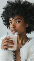 Woman with an afro drinking milk in a fur coat photo