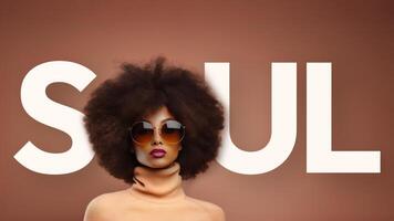 A woman with an afro poses in front of the word soul photo